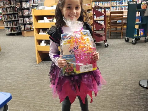 a girl holding a toy in a library