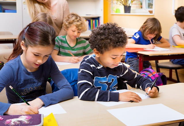 a few children sitting at desks