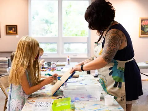 a woman cutting a child's hair