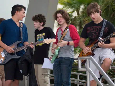 a group of people playing guitars