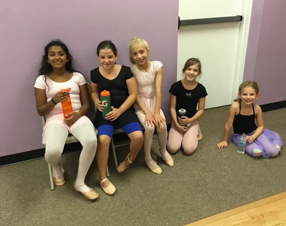 a group of women sitting on a bench