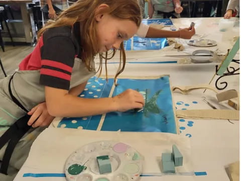 a girl painting on a table