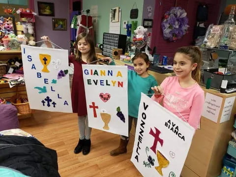 a group of girls holding signs