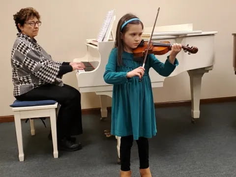 a girl playing a violin