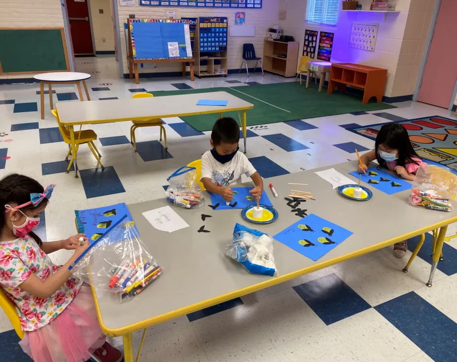 children painting on a table