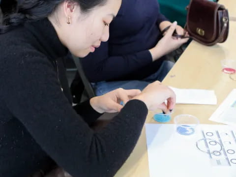 a man writing on a piece of paper
