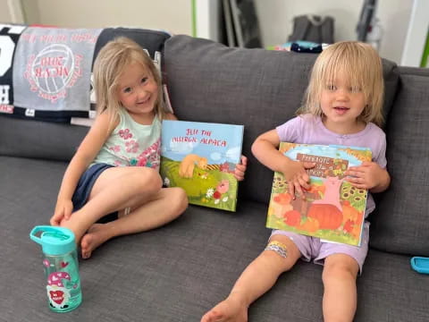 two children sitting on a couch