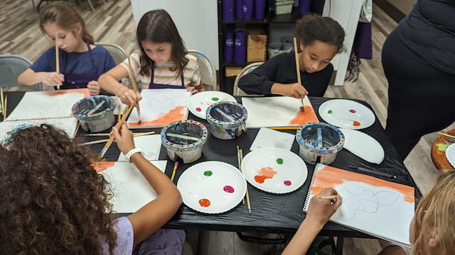a group of children painting