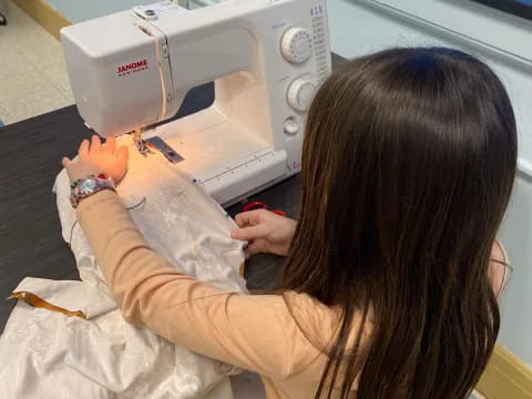 a person using a sewing machine