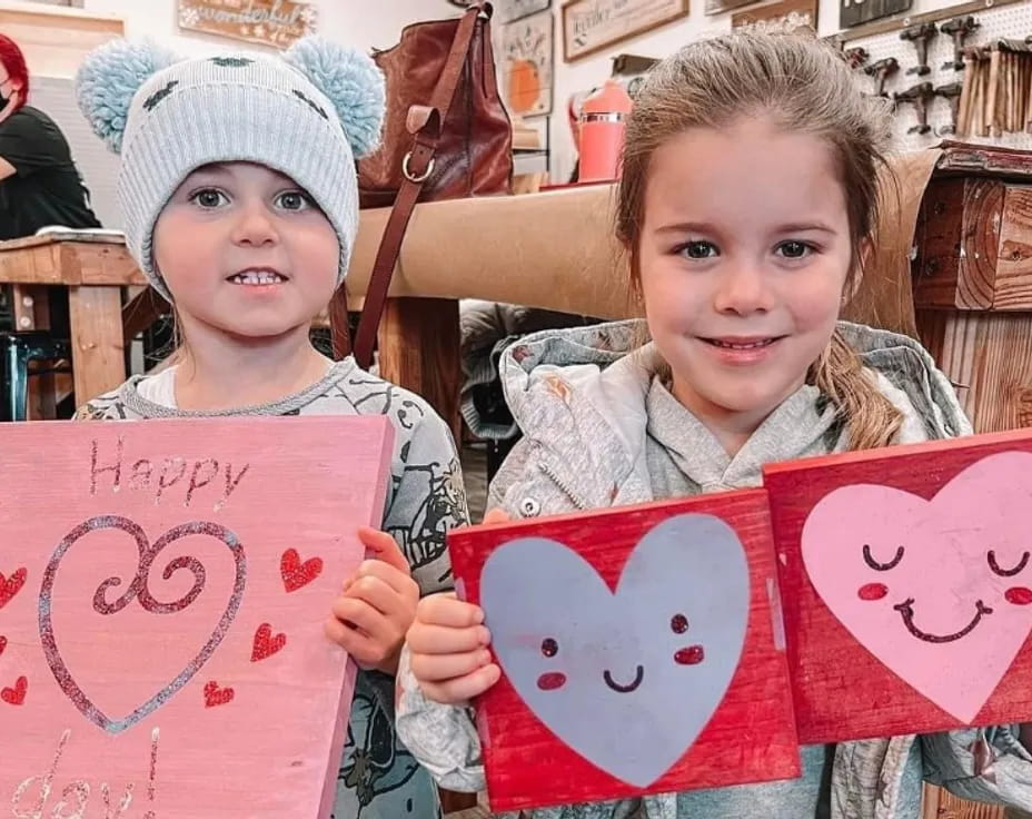 a couple of children holding signs
