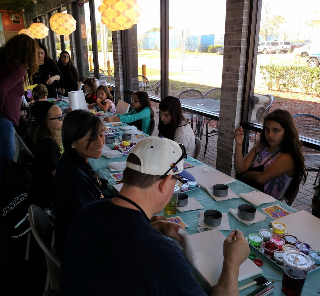 a group of people sitting at a table eating food