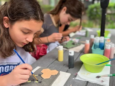 a few young girls painting