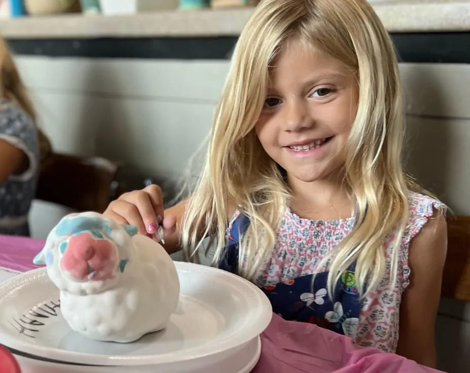 a girl holding a cupcake