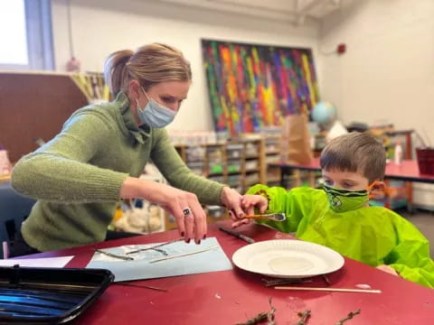 a woman and a boy painting