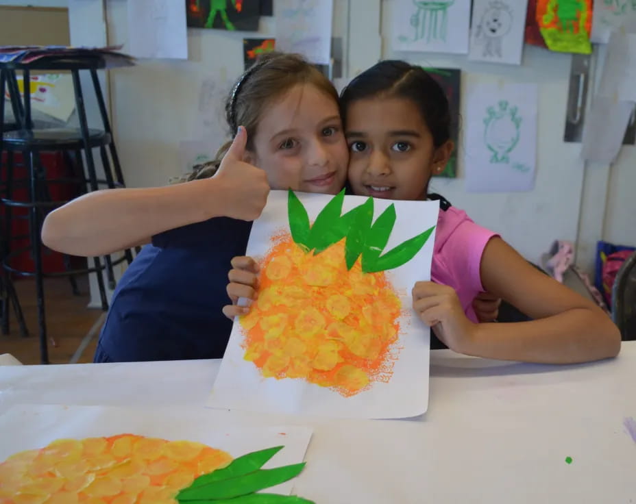 a couple of girls holding a puzzle