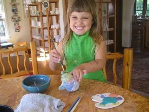 a girl painting on a table