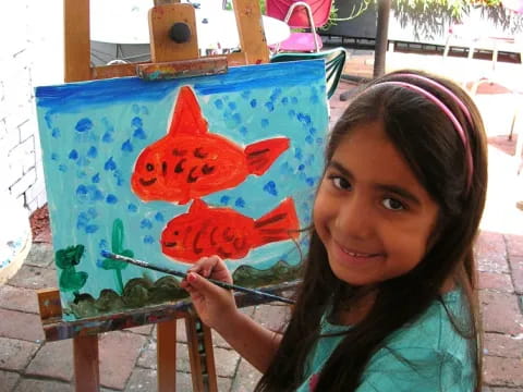 a girl holding a painting