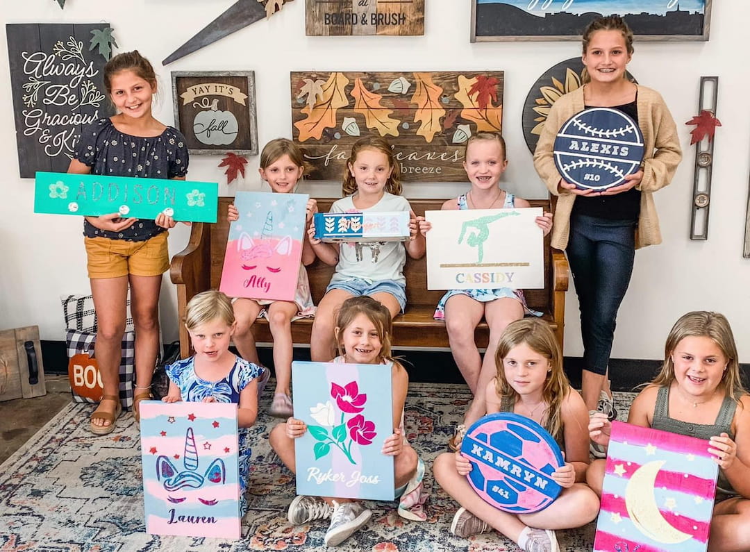 a group of children holding signs