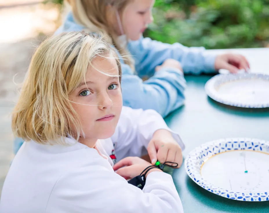 a young girl cutting a cake