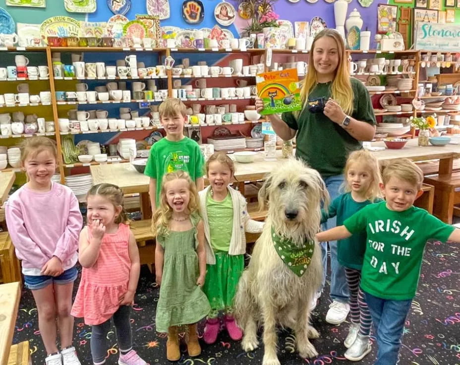 a group of children and a dog in a room with shelves