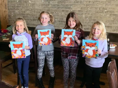 a group of girls holding up books