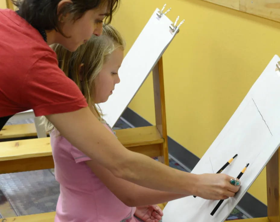a person drawing on a white board