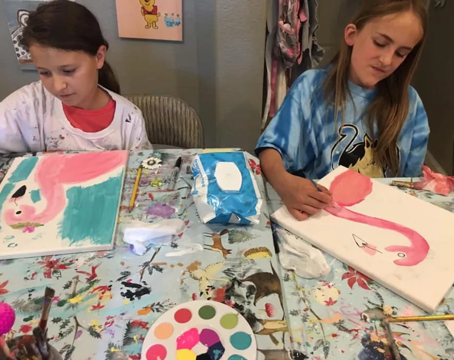a couple of young girls painting