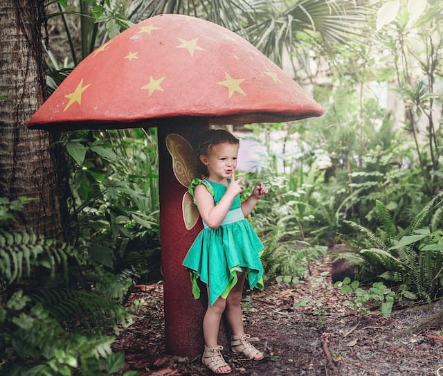 a little girl holding an umbrella