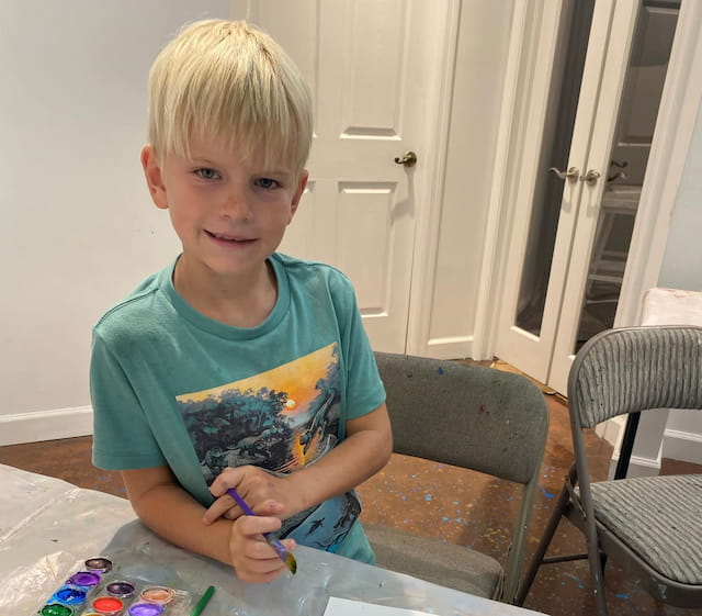 a boy holding a toothbrush