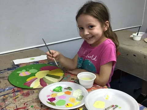 a girl painting on a table