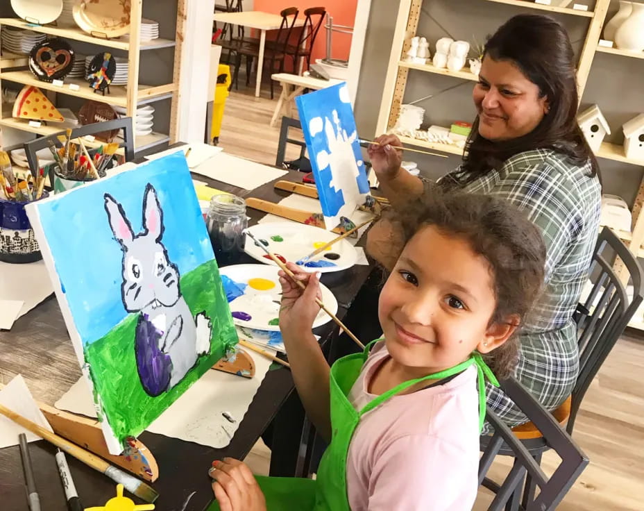 a person and a child painting