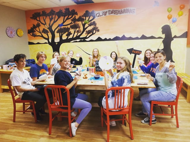 a group of children sitting at a table