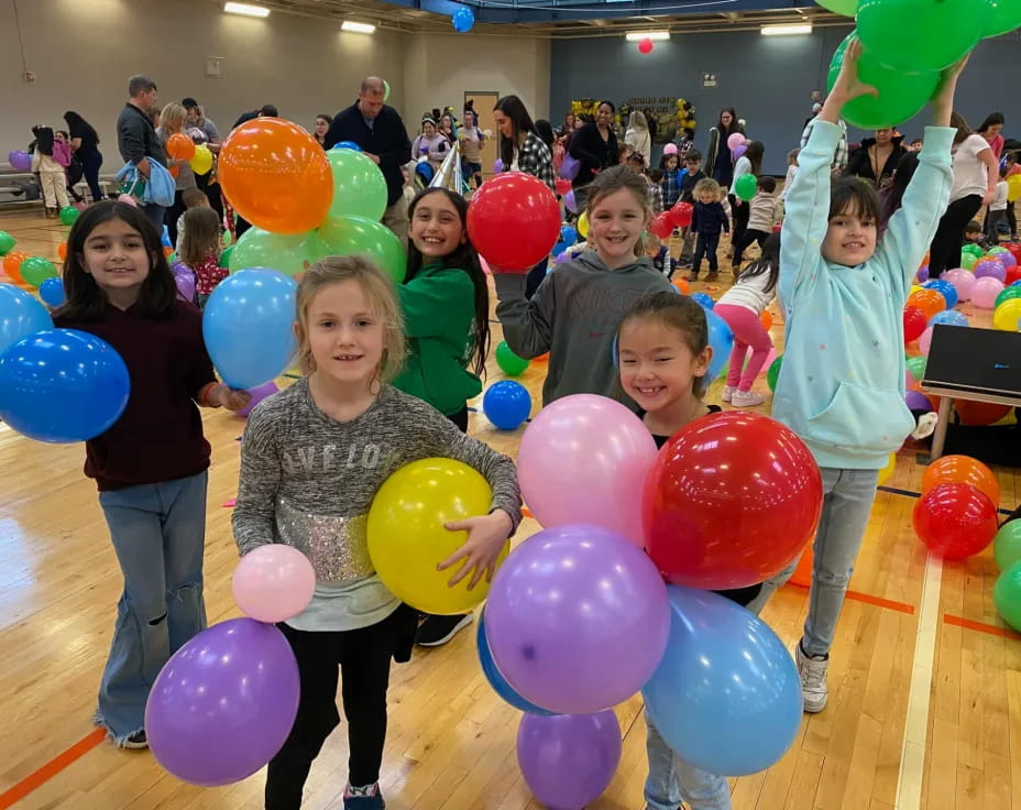 a group of people holding balloons