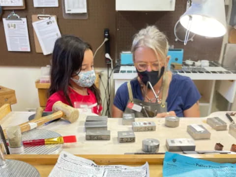 a person and a girl working on a project