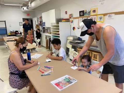 a woman showing kids something on the paper