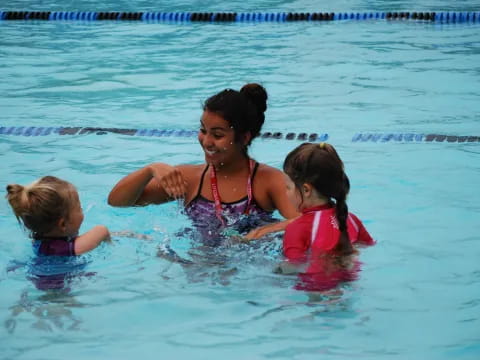 a man and two girls in the water