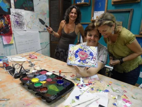 a group of women cutting a cake