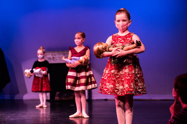 a group of children dancing on a stage