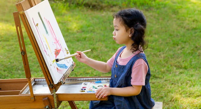 a girl painting outside