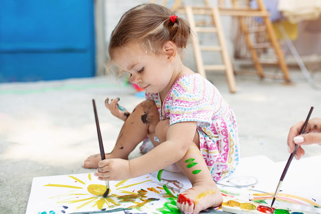 a girl painting with a brush