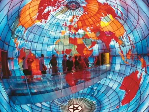 a group of people inside Mapparium