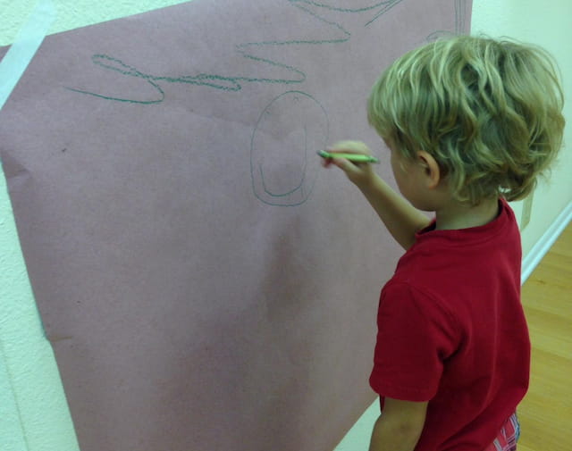 a child drawing on a white board