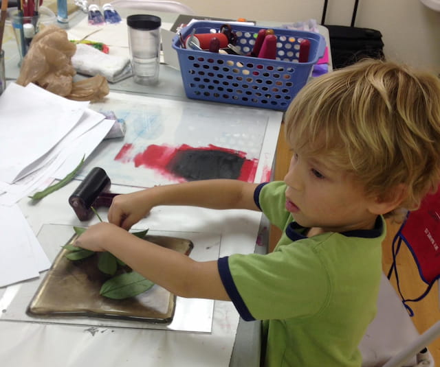 a child painting on a table