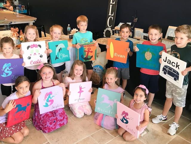 a group of children holding signs