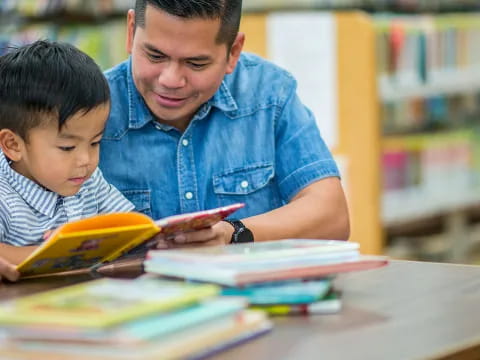 a person and a boy reading a book