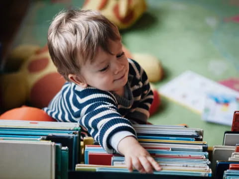 a young boy looking at a book