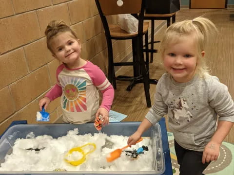 a couple of children playing with toys