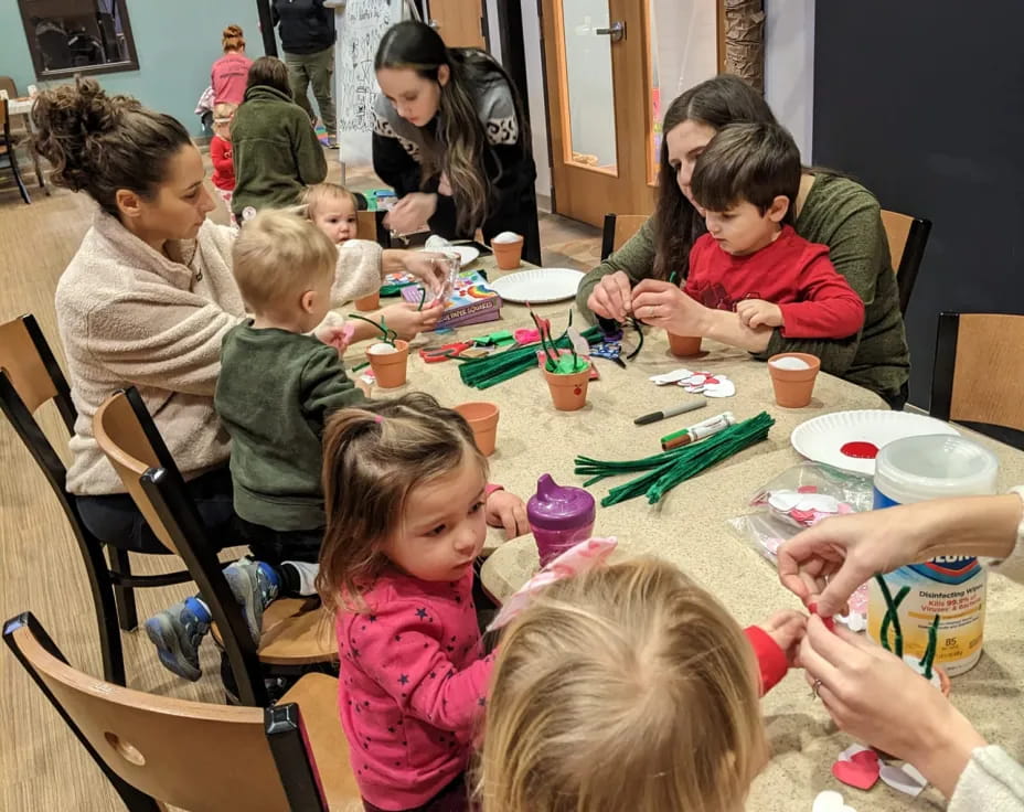 a group of children sitting around a table