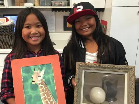a couple of women holding a box