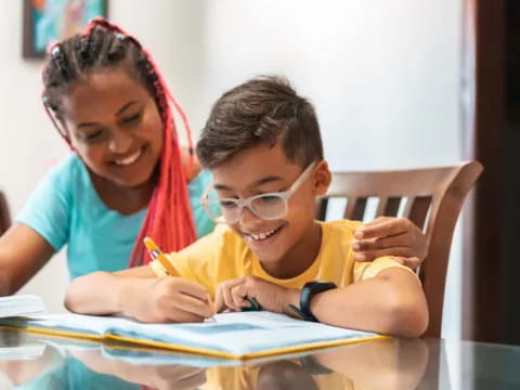 a person and a boy looking at a paper